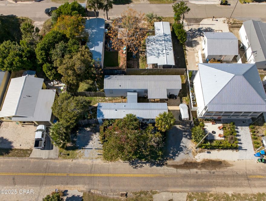 Exceptional opportunity to acquire two adjacent buildable lots in Panama City Beach with existing income in place and a clear path to redevelopment.

The property includes two mobile homes currently generating rental income, positioned across the combined parcel (not separately situated on each individual lot), offering flexibility for a buyer to maintain income while planning future construction.

The true value lies in the development potential. A newly completed home next door demonstrates what can be built in this location, providing a strong blueprint for future use. Sewer is already available across the street, helping simplify the development process, and plans and recent construction estimates are available to give buyers clarity on next steps.

Whether you choose to hold for income while planning redevelopment or move forward with building on one or both lots, this property offers a rare combination of cash flow, land value, and future upside. Opportunities to secure two side-by-side lots with income and proven build potential in Panama City Beach are limited.