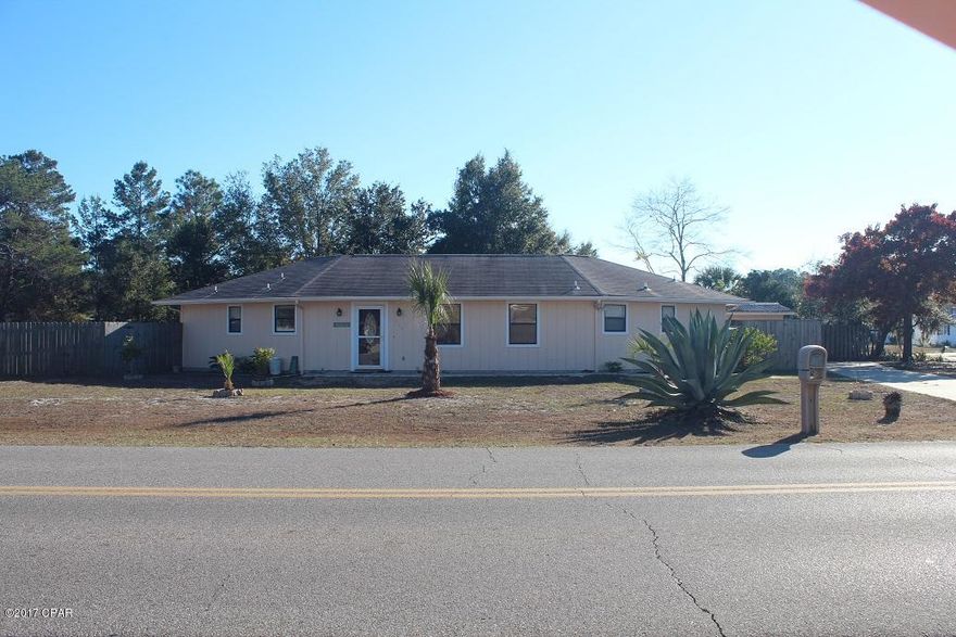 This is a nice home that is only a short drive to the Navy base and the beach.  This home would be perfect for year round living or a vacation home.  The home has been freshly painted inside and out and is in very good condition.  The vinyl flooring in great room and carpet in the bedrooms are new.  The home features a large great room with an open kitchen/dining area that is perfect for entertaining. There is a master bedroom on each side.  One master bath has a walk-in shower and the other master bath has a shower/tub combo.  The home sits on a corner lot with plenty of room and back yard access for an RV, boat, trailer, etc.  The property features a yard building, privacy fenced back yard, lemon tree and tangerine trees.  The roof was installed in 2009 and brand new water heater.