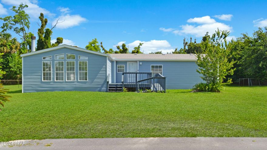 (Back on the market at no fault of the seller.)  Seller is very motivated.  Inspection is good.  Survey is available.   Come check out this Residential / Commercial piece of property. This triple wide home is ideally situated on a generous .96 acre corner lot.  Featuring three bedrooms and two full bathrooms, this residence is designed for ease of living and accessibility, complete with a large front porch and a handicapped ramp.   Step inside to find a welcoming living room that seamlessly flows into the dining area, creating an ideal space for family gatherings and entertaining guests. The master bedroom, conveniently located to the right, offers privacy and tranquility. To the left, the heart of the home features a spacious kitchen with ample storage and counter space, adjacent to a practical laundry room to include a utility sink. Located just off the kitchen are two bedrooms and another full bath.  Additionally off the kitchen, indulge in the cozy ambiance of a den adorned with large bay windows that fill the space with natural light.  An exterior door from the laundry room presents a perfect opportunity to add a driveway for easy access. Outdoor living is just as impressive, with sliding doors leading to a large back porch overlooking the large backyard. Complete with a storage shed and an attached lean-to, an ideal spot for your barbecue smoker and outdoor equipment.  Backflow system has been installed for irrigation.