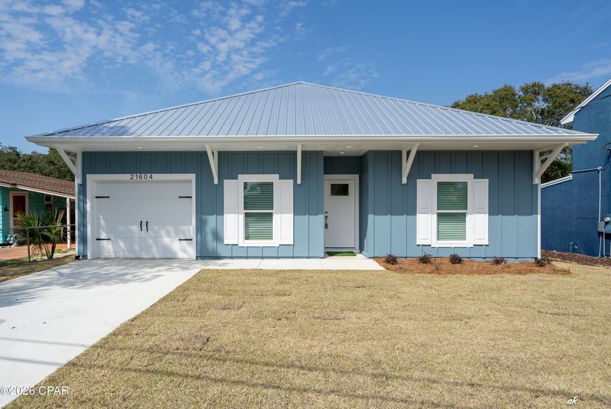 Welcome to 21604 Dolphin Ave, a beautifully crafted brand-new construction home in Panama City Beach offering the perfect blend of modern design, durability, and unbeatable location. Featuring 3 bedrooms, 3 bathrooms, and a single-car garage, this thoughtfully designed property is ideal as a primary residence, vacation home, or high-performing short-term rental.

Inside, you'll find luxury vinyl plank flooring throughout, creating a seamless and low-maintenance living space. The kitchen showcases white shaker cabinetry with soft-close drawers and doors, generous counter space, and two spacious walk-in pantries--one perfectly suited as an owner's closet for those considering a vacation rental setup.

The primary suite offers a spa-like retreat with a walk-in tiled shower and double-sink vanity, while ceiling fans in every bedroom provide comfort year-round. A durable metal roof adds long-term value and coastal resilience.

Step outside to a fully fenced backyard, perfect for relaxing after a beach day, entertaining guests, or accommodating pets.

Location is everything, and this home delivers. Situated just minutes from the sugar-white sands of the Gulf, you're perfectly positioned between the charm of 30A and the energy of Panama City Beach. Spend your days exploring nearby favorites like Rosemary Beach, Alys Beach, and Seaside, dining at local hotspots like Shades Bar & Grill, George's at Alys Beach, and The Big Chill, or enjoying shopping and entertainment at Pier Park.

With its prime location, durable construction, and thoughtful layout for vacation rental use, this property presents an outstanding opportunity for strong short-term rental income potential while still serving as a beautiful coastal retreat.

Come experience the best of the Emerald Coast lifestyle at 21604 Dolphin Ave.