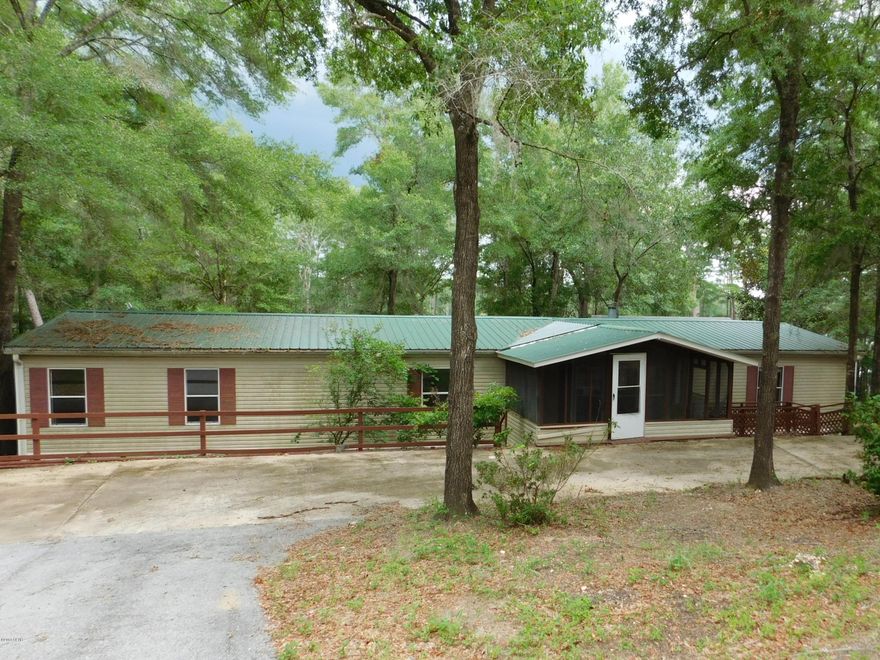 Sit back and enjoy the view of Bowen Lake with this large 3/2.5 doublewide mobile home. Home offers spacious rooms. Kitchen has lots of storage, island. Dining area is open to living room with gas fireplace. Split floorplan with master bedroom and master bath, 2 additional bedrooms and hall bath. Each bedroom has walk in closets. Laundry room has sink, storage, pantry and half bath. Sliding glass doors in living room lead to deck with a great view of the lake and access upstairs workshop storage. Workshop with lean to. Portion of back yard is fenced. Screened in front porch. Concrete circular drive. 2.49+/- acres. Perfect for weekend getaways or a full time residence.