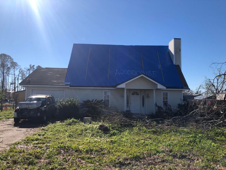 Extensive hurricane damage but lots of potential for this large home. The home offers an open living room with fireplace and tile flooring. The kitchen has lots of cabinets and center island with breakfast bar. The massive master bedroom is on the first floor with a Hollywood style master bath and enormous walk in closet. There is an additional bedroom on first floor with full bath and 2 additional bedrooms and full bath on the second level. The loft overlooks the living room and can be used as a 5th bedroom, an office, or just an extra room. In addition there is a single car garage with extra storage space. The home needs lots of work but at this price, it wont last long!