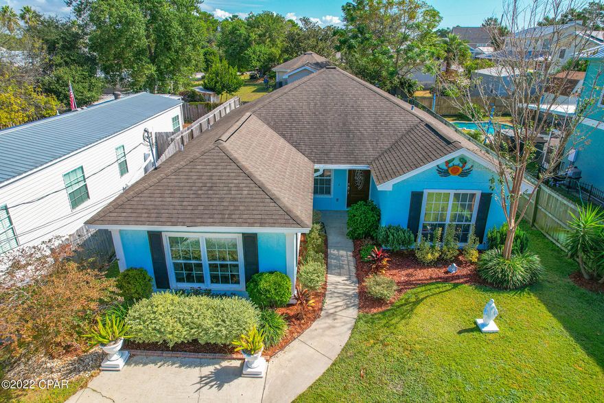 Prime location at the west end of Panama City Beach just 2 blocks from the beach! SHORT TERM RENTAL ALLOWED!! Open living area with vaulted ceiling and split bedroom floor plan. The home has very high end engineered hardwood floors throughout. Extras include Granite countertops, stainless steel appliances and crown molding throughout. The kitchen is large with a beautiful breakfast bar, plenty of cabinets and a pantry! A large screened porch was added with a metal roof on it, mounted television, and built in fan. The 4th bedroom is 21 x 14 feet and could be used as additional bedroom or entertainment room. There is a 7x6 storage room with a full size freezer that conveys as well as the washer and dryer. $5,000 in seller concessions towards points or updates! What a find!