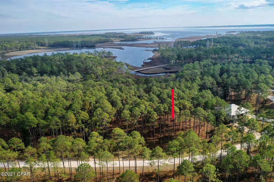 It is time to discover Rivercamps! This is a wonderful lot to build your dream home on. It will have amazing views of Crooked Creek! Rivercamps on Crooked Creek is a unique neighborhood with large lots, surrounded by three bodies of water: West Bay, Crooked Creek,and the intercoastal waterway.  It is a boaters dream but has amenities for the whole family including the Pier, Riverhouse, library, community pool, gym, kayaking, biking, walking trails, day docks, boat ramp, ping-pong, playground  and more... This tranquil neighborhood is also close to the beach,  airport, restaurants and Pier Park.