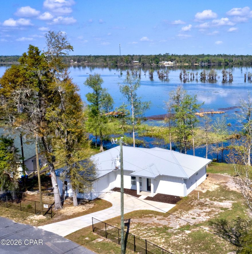 Experience the ultimate Deer Point Lake lifestyle in this stunning new-construction waterfront retreat. Located in the Lakeshore Heights community of Youngstown (near Southport), this modern home perfectly blends luxury design with peaceful lakeside living.

The open-concept floor plan is bathed in natural light, featuring breathtaking lake views from the kitchen, living room, and primary suite. The gourmet kitchen is an entertainer's dream, complete with premium granite countertops and a layout designed for seamless flow. With two spacious bedrooms, three full bathrooms, and a versatile flex room--perfect for a home office, gym, or guest suite--the home adapts to any lifestyle.

Outdoor highlights include a private dock for direct lake access--ideal for boating and fishing--and a two-car garage. Situated approximately three feet above the flood zone for added peace of mind, this home offers both beauty and resilience. You're just minutes from three public boat landings, including the popular Cherokee Landing.

Don't miss this rare opportunity to own a brand-new lakefront home on Deer Point Lake. Schedule your private showing today!

Owner financing is available for qualified buyers.  Please inquire with listing agent for details.