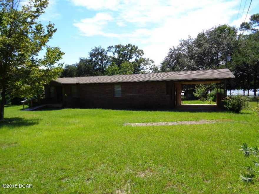 BRICK HOME ON LAKE COMO IN WEWA. HOME IS FENCED AND HAS A DOCK ON THE LAKE. HOME FEATURES 3BR/1BA WITH LG. DINING/LIVING ROOM COMBO, AND WITH A GREAT ROOM ON THE BACK OF THE HOME THAT HAS A WRAP AROUND PORCH OUT BACK, THAT OVER LOOKS THE LAKE. THERE ARE SHADE TREES AND SEVERAL FRUIT TREES. THE HOME HAS A COVERED CARPORT ON THE R END. THE HOME IS VERY SPACIOUS ON THE INSIDE.  PROPERTY A SHORT DISTANCE TO THE RIVER AND THE BEACHES, ST JOE OR MEXICO BEACH. INFO FROM PROPERTY APPRA. PLEASE VERIFY IF IMPORTANT. ----- CALL FOR YOUR APPOINTMENT TODAY.