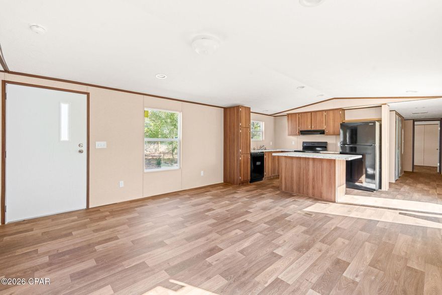 HUGE PRICE DROP! Welcome to this BRAND NEW 2026 Model, 3 bedroom/2 bath, single-wide manufactured home featuring cozy interior and exterior colors and a thoughtful layout. This home is apart of the Paradise Lakes Community, so you'll have access to the lakes, boat ramp, clubhouse, & everything else Paradise Lakes has to offer! The open floorplan creates a bright, welcoming living space, complemented by a versatile flex/bonus room ideal for a home office, playroom, or extra living area. The kitchen offers black appliances, ample cabinetry, and an island perfect for everyday living. The spacious primary suite includes a luxurious bathroom with a soaker tub and huge separate stand-up shower! The primary bath is also home to a large walk-in closet for all your storage needs. This new home sits on half an acre just waiting for you to add your personal touches after you call this place HOME! The front and backyard is level and clear directly around the home making it the perfect canvas for your outdoor storage needs. Location is key and this house is located about 2.5 miles (7 minutes) from Hwy 77. You'll have the ''country'' feel without being too far from all the attractions that Chipley, Lynn Haven, and Panama City have to offer! Come check it out!