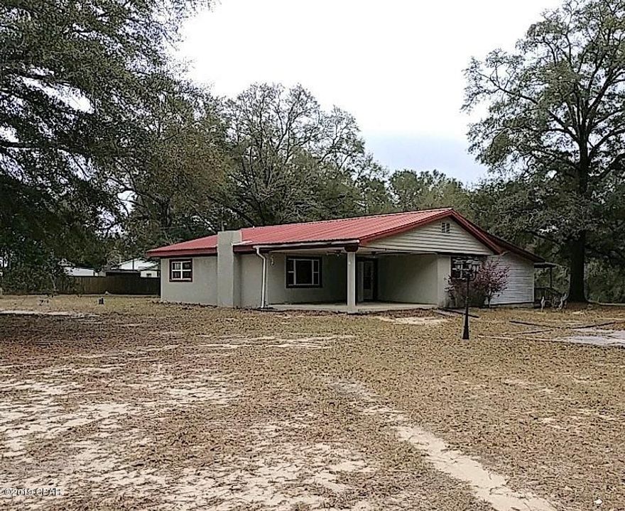 4-Bedroom, 2-1/2 Bath Home on 2.3 acres on the east side of DeFuniak Springs.  Living room is spacious and has a wood-burning fireplace.  The master bath has a jacuzzi and a separate shower.   Metal roof, central heat and air and a large yard with plenty of room for kids or animals to play.  Attached one-car carport and a nice covered back deck that runs the length of the home. Sections of the 2.3 acres are wooded.