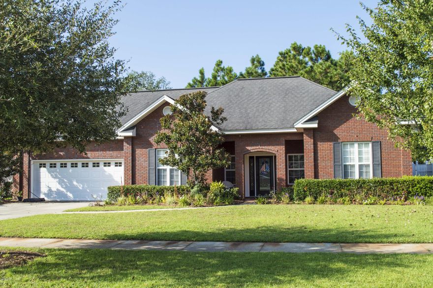 This beautiful all brick custom home in The Hammocks Subdivision could be your next dream home. Centrally located to Tyndall Air Force Base and Navy Base. Upon entering, you will be impressed with the high-end features.  The foyer is inviting and has large storage closets on both sides.  Looking into the living room, you will quickly notice the crown molding, vaulted ceilings, gorgeous hardwood floors, and a cozy electric fireplace. This home has a formal dining room with trey ceilings, an updated kitchen, a room upstairs with full bathroom, large spacious bedrooms, and generous storage. Master bedroom features trey ceilings, Jacuzzi tub, tile shower, large closet, and double vanity. The home is wired for a surround sound system and alarm system. New carpet adorns the upstairs room and much of the home has new paint.  The back yard features a screened-in porch and a large vinyl fence, perfect for kids and pets. This home is very well cared for and shows pride of ownership.