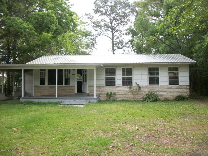 Fixer Upper. AS IS. Cute cottage.  hardwood floors, knotty Pine Paneling in living area & hall, sheet rock in bedrooms and kitchen, new metal roof, double pane aluminum windows, central heat and a/c, carport, and mostly fenced yard.  Great location in Lynn Haven.  Zoned mixed use.  Potential office location.  1,152 SF includes laundry room with 107 SF.