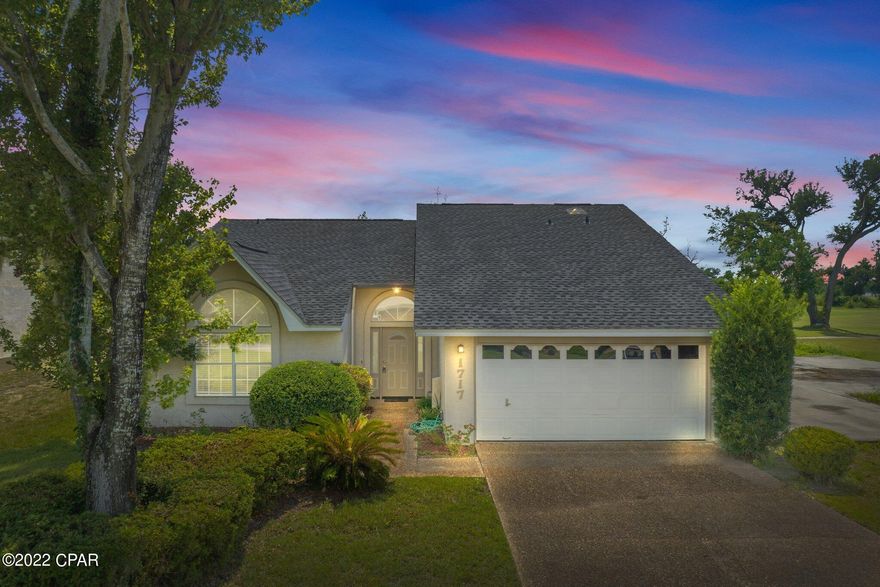 This beautiful 3 bed 3 bath 1,960 sf home has views overlooking the golf course in Lynn Haven's Panama Country Club.  The house features an open concept with cathedral ceilings, large kitchen with granite countertops, long breakfast bar, and pantry.  There is a dining area and living room that are along a wall of windows and sliding glass doors for lots of natural light.  The living room has a wood burning fireplace and the sliding doors take you to the back open patio.  The master bedroom and bathroom are downstairs along with a large guest room, full guest bath and laundry room.  Upstairs you have another large bedroom with a full bathroom.  The house is light and bright and very peaceful.  The neighborhood is perfect for walking and biking with views of the bay.  Panama Country Club has memberships available to use their 18 hole golf course, clubhouse and pool.  Pool only memberships can be purchased separately.  The roof was replaced in 2019, AC in 2017 and the water heater in 2021. The kitchen appliances were purchased in 2021. There is a two car garage attached.  Make plans to see this property today!