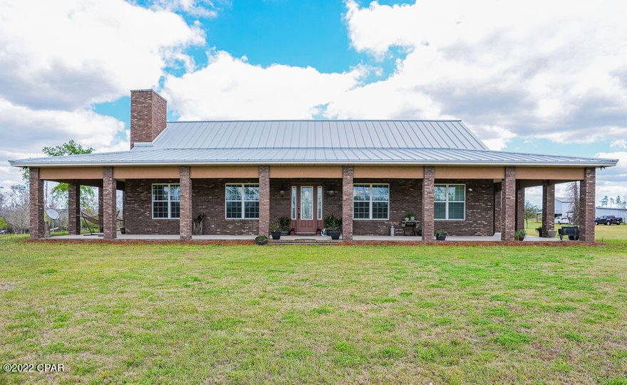 Introducing 8114 Ed Lee Road, Bay County's finest farm!   This well kept farm consists of 27 acres nestled in NE Bay County on a very private paved road.  The 3 bedroom 2 bath  home is  built from Poly Steel construction making it nearly indestructible and very energy efficient.  The concrete filled poly steel walls are covered in brick and measure 15'' THICK!!!  The roof is a hip roof covered in standing seam steel for more durability and wind resistance.   A covered porch wraps completely around the exterior.  The grand interior of the home features 12' ceilings in the living areas and 10' in the bedrooms making the already large space feel much bigger.  The kitchen is a chefs dream with a Mediterranean feel with custom wood cabinets and a custom MASSIVE center island. Just off the kitchen is the laundry room with even more cabinet space, perfect for self sustaining farm living. A custom fireplace is the focal point of the expansive living room complete with 3/4'' tounge and groove hickory floors throughout. The split floorplan features a luxurious master suite with oversize walk in closet, garden tub and a custom shower with 6 sprayer shower head. Bedrooms 2 and 3 are also very large and separated from the master for privacy. This amazing farm has a 40x60 enclosed barn, a 24x24 2 story barn that is partially finished for living space and a 24x24 utility barn. The pond is stocked and the fruit trees and bushes are abundant. There is even a sugar cane patch and a vegetable garden. For the farmer there are 3 separate pastures and irrigation throughout the entire 27 acres. Take a look at the  pictures and call your Realtor today!! This is your chance to own a slice of country heaven just 25 minutes to Panama City!!!