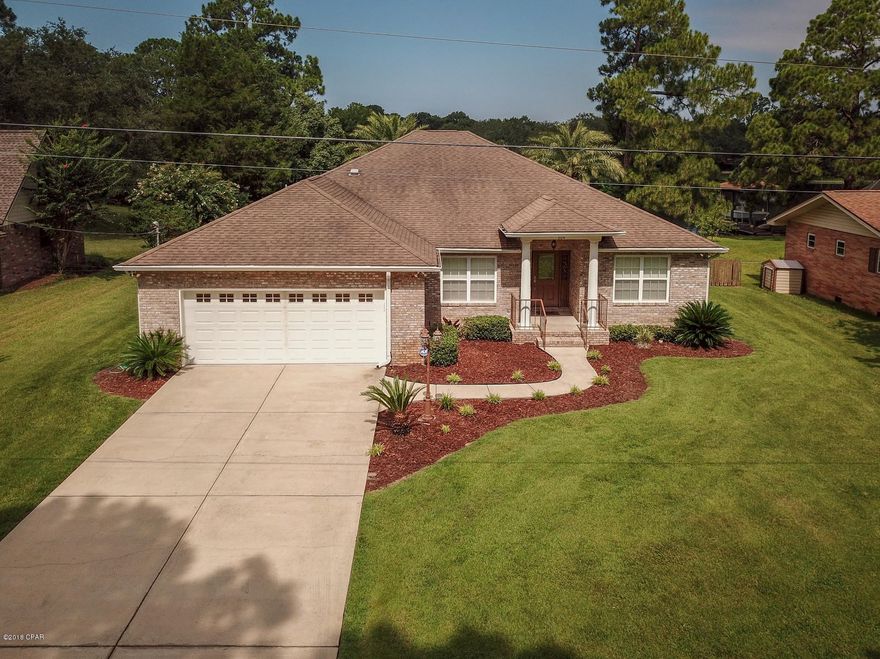 DEEP CANAL with GULF ACCESS WATERFRONT HOME IN LYNN HAVEN! SALT WATER POOL & HOT TUB- POOL HOUSE- BOAT LIFT with REMOTE OPERATED CONTROLS, DOCK with ELECTRIC & WATER & SEA WALL! Move in ready! New paint & New flooring! The interior of this all brick home features 3 large bedrooms, 2.5 bathrooms with a Mother in Law Suite/Pool house with full bath- there is an access door to bathroom from pool with wash down (entire room) as well as detached guest room with french doors for view of water. The home has a newer Salt Water Pool with hot tub that can be heated with the natural gas heater. You can heat just hot tub or pool & hot tub. The living room boasts a 10 foot ceiling, a gas fireplace with mantle & built-in cabinets and bookcases. There is an additional office or bonus room off the living room with access to the large screened porch. The formal dining room is open to the living room but is set apart by two decorative columns. The newly remodeled kitchen features solid wood cabinetry, stylish stainless steel appliances, a 5 burner gas range built in oven & beautiful granite counter tops. The Master Bedroom area is an owners retreat featuring water views, large Master Bath with Tile Shower, Double sinks & make up desk area, there is also a spacious linen closet & Huge walk in closet. The additional Bedrooms are large and feature walk in closets in both rooms. There is an additional full bath between the bedrooms & a nice sized 1/2 bath off the kitchen. This home has been perfectly maintained & pride of ownership is truly evident in this one of a kind property! Other additional features include: Gas Hot water heater, Closed cell roof deck 
Low utility bills, Zoysia grass, Sylvester palms at pool (3500 each)
Sprinkler system, Fish Cleaning Area, 8x13 Covered Area For Future Out Door Kitchen, Cable run to master bath and garage for treadmill use & MUCH MORE! This Home is Truly a MUST SEE! Call for your Private Showing Today! ***All measurements approximate, please measure if needed***