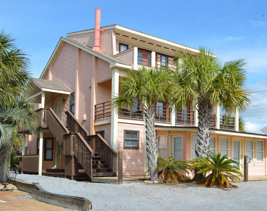 ATTENTION INVESTORS! This Gulf View Furnished Panama City Beach Home has Many Possiblities! Use it as One Large Beach Home with 6 Bedrooms, 5 Full Baths, 4 Kitchens, 2 Spacious Decks with Gulf Views and Enough Parking for ALL  that can stay in this home! OR it could be a quad plex with 3 lock out apartments on the first floor and a 4th on the second and third floors. All 4 Kitchens have been upgraded with solid wood cabinets, granite and stainless appliances. Tiled floors, fireplace in main living area, upgraded baths, a basement for storage and  beach access is in front of home making it super easy to go to the beach! This is a Must See Panama City Beach Home as Gulf View at this price are hard to find! Buy today and have it ready for the summer rental season!  Call Today For Your Showing bedroom, master bath, walk in closets and a porch with incredible views. This home is located in a quiet area of Panama City Beach with beach access across the street.