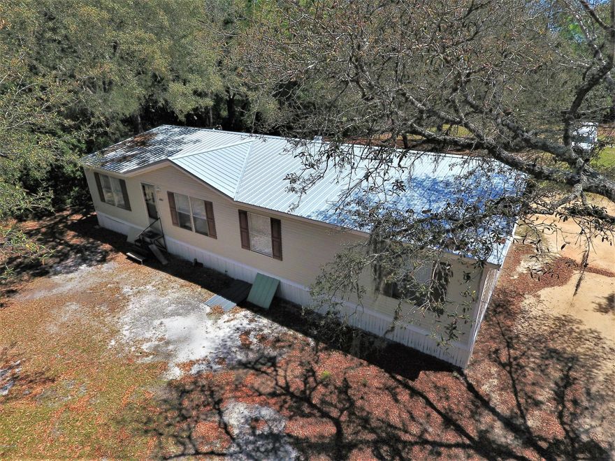 8902 SOUTH Burnt Mill Creek Road, walking distance to the boat landing and just over half an acre of land, featuring a three bedroom and two bath mobile home with a brand new roof and over 1,700 square feet of living space. Burnt Mill Creek is a private area, very quiet and peaceful, fishing and boating are the norm. The lot has plenty of room with ample space for a RV, Boat, Workshop or any number of ''toys.'' No HOA fees here and a weekend getaway or full time residence, both are doable! Check out the aerial photos for the close proximity to the creek. Also, minutes from the NWFL Airport, 6 miles from Hwy 77 and 6 miles from Hwy 79. Come visit today!