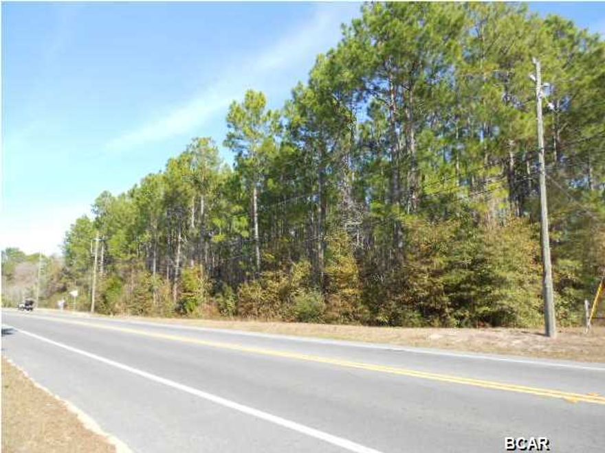 7.23 acres. Over 500 feet on paved road County Rd 2301!!!  Get that great, peaceful country feeling without the 45 minute drive or the huge mess of dirt roads!