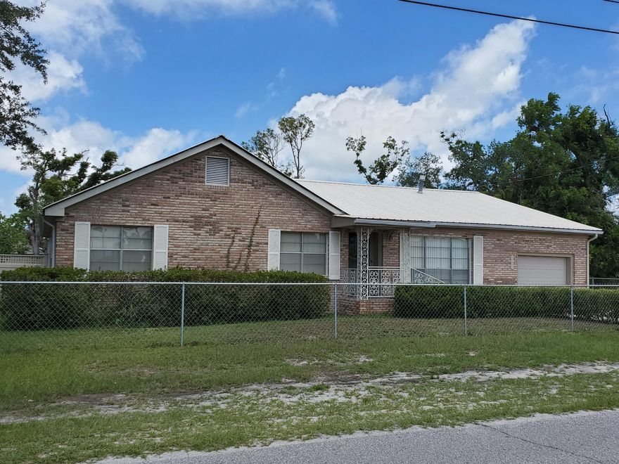 CURRENTLY UNDER CONTRACT, SELLER ACCEPTING BACKUP OFFERS. LARGE 4-sided brick home on 100x150+ lot full of fruit trees! Don't miss this 2,478 SF 3bd/2bth home featuring formal living room, dining room, fam. room, lg. eat-in kitchen, laundry room, mudroom off single car garage, den w/stone fireplace, large screened Florida room patio, and MORE! Another living space everywhere you turn in this sprawling single level home located in a very quiet neighborhood. Across the street from a church, the area offers immediate access to Hwy 231 corridor to PC or slip into Lynn Haven from nearby Baldwin Rd.  Outdoors offers shade trees, & manicured  fenced yard with fruit trees galore. Large carport for add'l covered parking w/gated access to backyard and covered, fully screened back porch. You'll have a hard time finding this much home at this price! Don't miss viewing this low maintenance brick home!