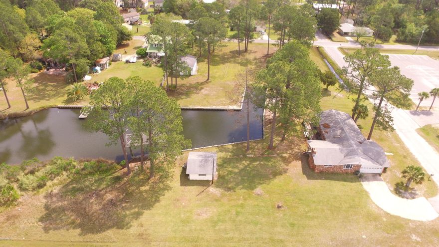 Opportunity of a lifetime to own land surrounding a finger canal that extends off of North Bay! This traditional, ranch style brick home with a large living room, kitchen and family room adjoins Kinsual Park. It has a 2 car attached garage and another detached huge parking garage/workshop AND yet another workshop and covered boat dockage! This amazing location is perfect for the family that wants to have it all--a sturdy brick house with plenty of land, plenty of waterfront, and all the amenities of a city park right out your front door! Kids can play on the playground equipment, waterfront pavilions are perfect for family picnics, softball fields offer plenty of room to play soccer, throw Frisbees, whatever you enjoy. It's all right at your doorstep!