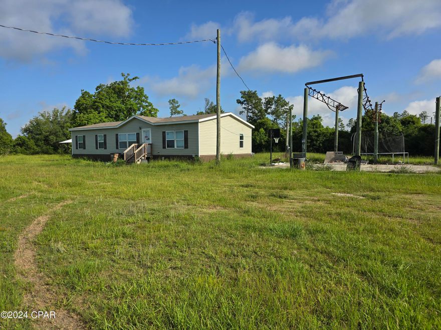Investor Potential! 3 Bedroom 2 Bath bank owned property on 1.25 MOL Acres in Wewahitchka! This home sits on a corner lot with Highway 71 frontage. The home has a split floorplan layout, with a large living, dining, and kitchen area. This property is priced to sell! Schedule your showing today!