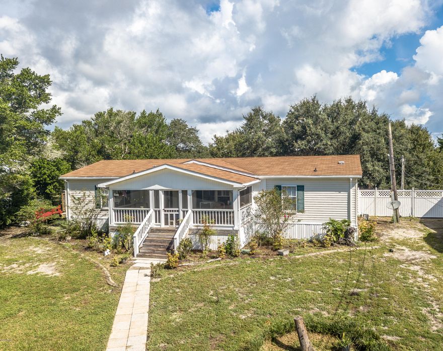 LOCATION! LOCATION! Large lot on the west end of the beach within walking distance to Lake Powell.  3/2 MH with a  fully fenced yard, great spacious screened front porch...a room has been added that it could be used for an office, game room or guest bedroom...Sprinkler system using well water.....Come and enjoy the Beach, Lake Powell, Pier Park and within a 5-10 min drive you are on 30A.....Call for your private showing......