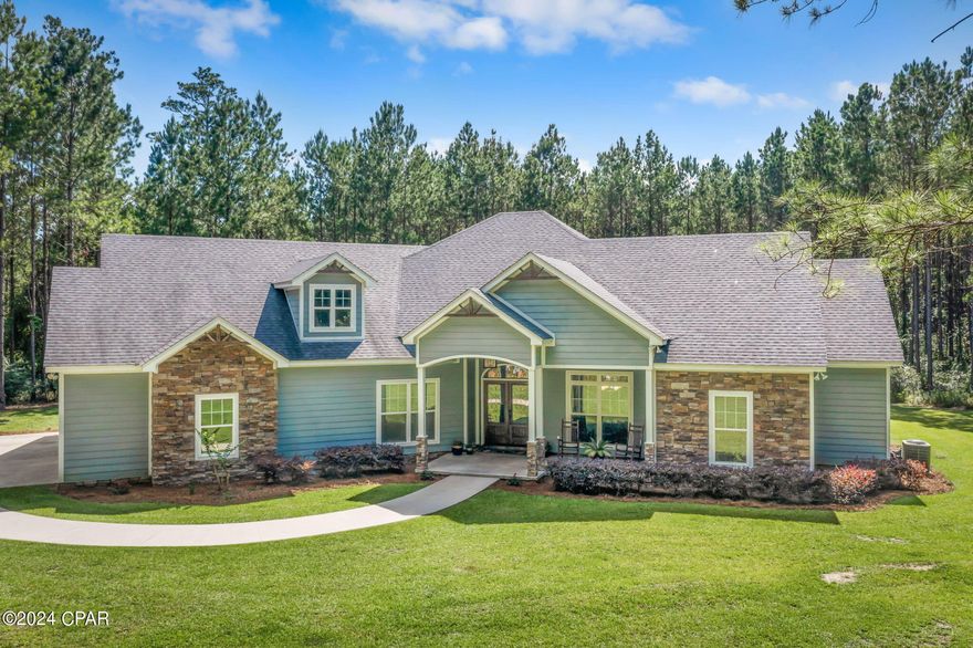 Nestled among the pines sits this Craftsman-style home, secluded on the highly sought-after Piney Grove Rd, awaiting its new owners. Step inside and you're welcomed by an open concept floor plan, elevated ceilings, and sleek engineered floors. Entertain guests in the expansive kitchen, featuring custom cabinetry, granite countertops, double wall oven, gas cooktop, pantry, and an island with views extending to both the pool and the living room, boasting elegant, coffered tray ceilings. The master bedroom is a true retreat with vaulted beamed ceilings, an ensuite bathroom featuring his and her vanities, soaking tub, a double-entry custom-tiled shower, massive closet, and direct access to the pool. Two additional bedrooms share a Jack-and-Jill bathroom, while two other guest rooms each have their own ensuite baths. No expense was spared outside, where you'll find an oversized covered back porch with a wood ceiling overlooking the 30x12 gunite pool complete with a hot tub and waterfall feature. Additional exterior features include a climatized 3-car garage, lush landscaping, circular driveway and access to a serene pond, enhancing the peaceful ambiance. This exceptional home is a rare find, offering luxury, privacy, and tranquility in one perfect package.