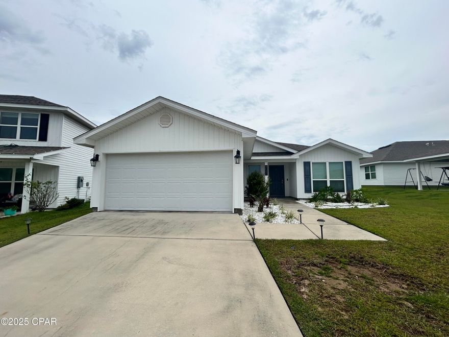 Beautiful 3 bedroom, 2 bathroom home located in Panama City, FL. This cozy house features carpeted master bedroom, a two-car garage, fenced backyard, walk-in closet, open kitchen, wood LVP flooring, spacious master bathroom, covered back porch, laundry room with washer and dryer, and additional shelves for storage in the garage. With its convenient location and desirable amenities, this home is perfect for anyone looking for a comfortable and functional living space.