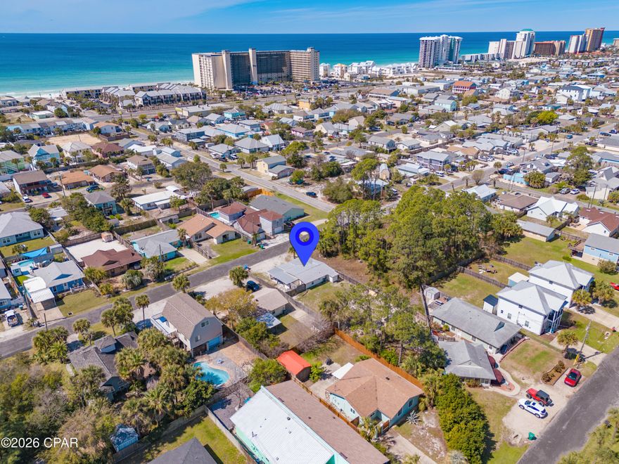 Fully renovated beach cottage and RENTAL MACHINE only .3 miles from the Gulf! This stunning 3-bedroom, 2-bath coastal home sits on a huge lot with no HOA in the heart of Lower Grand Lagoon, offering the kind of space that is nearly impossible to find this close to the water. Every inch of this cottage has been meticulously updated, including a 2020 metal roof, HVAC, Hardie Board siding, vinyl windows, septic system, PEX plumbing, and copper wiring. The coastal interior shines with granite countertops, white cabinets, stainless appliances, wood-look tile flooring, and updated fixtures throughout. All of the furnishings convey to the new buyer. Beyond the beautiful renovations, this property is a proven high-producing investment that has consistently delivered impressive results, generating $58,642 in 2023, $50,378 in 2024, and $45,591 in 2025. It is currently self-managed and the seller would be happy to share his process and vendors so a new buyer could continue. The massive yard provides plenty of room to add a private pool, while the oversized driveway offers an abundance of parking for a boat, jet skis, and golf cart. An amazing covered front porch offers the perfect hangout, while the private outdoor shower makes cleaning off the sand effortless after a day at the beach. This prime location puts you mere blocks from the community boat ramp and minutes from the area's best-loved dining spots like Schooners, Patches, and Finn's, offering guests the ultimate coastal lifestyle with world-class boating, fishing, and white sandy beaches just down the street. This property perfectly balances a relaxed coastal vibe with a proven track record of rental success. Schedule your showing today. A video tour is also available