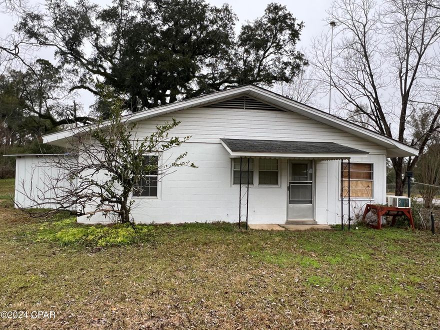 Here's a 2/2 but could easily be a 3/2 Block home in the center of Greenwood with 1/2 acre and detached 2 car garage and attached 2 car carport.  Home has many possibilities.  Might be able to make a duplex but large rental or your forever home.  Will need some work but has great potential.  Very convenient to the new grocery store, Dollar General Store, Bank and P.O.  convenient to Marianna and Dothan.  Price to sell.