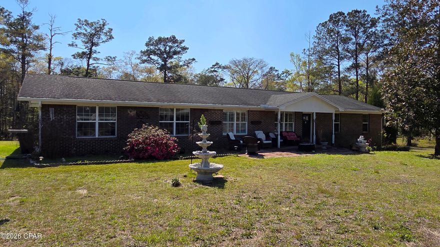Price Improvement-Take Another Look! 
3 bed, 2 bath brick home on 1.35 acres with Sandy Creek flowing through the backyard. The home features a spacious dining room, a dedicated laundry room, and a functional layout ideal for everyday living. Additional features include a nice sized garage, separate storage room, RV power hookup, and above ground pool. Just minutes from popular freshwater springs and 45 minutes from Panama City Beach.