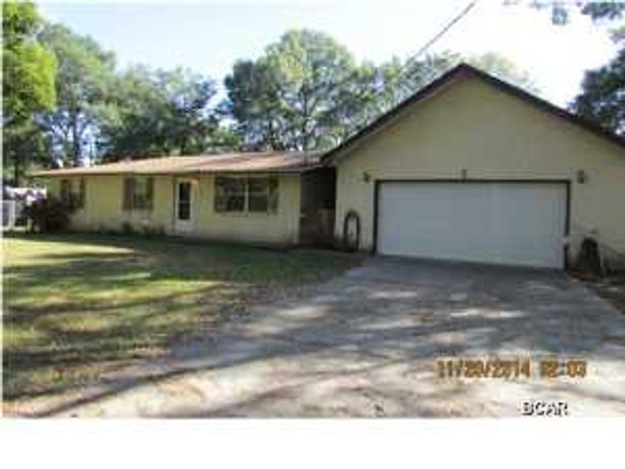 Nice 3 bedroom 2 bath home situated on 1 acre of land which includes 50 ft. on a small canal that has Deer Point access according to the seller. The seller has had a pontoon boat in the past and says water is navigable. There is an over sized separate garage which would make a great place for your weekend projects included in the garage is an office. The kitchen has been updated with new cabinets, counter tops and appliances. All ages, sizes including sq. ft. are approximate measure if important. Seller says to bring all offers!!!