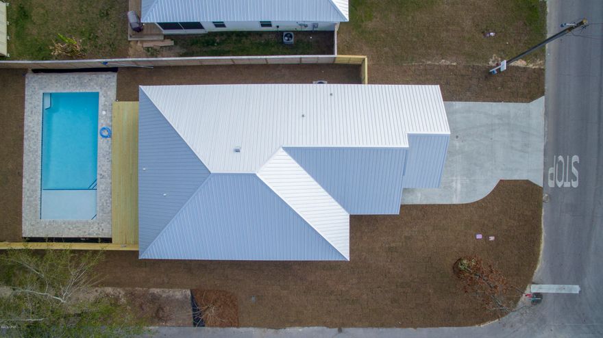 UNDER CONTRACT, SELLER ACCEPTING BACKUP OFFERS on this beautiful 3bd 2ba new build has an open floor plan. Custom cabinets throughout and quartz countertops. Washer/Dryer hookup both inside and in garage and tankless gas H/W tank with recirculation. Tray ceiling in living area and master. Master bedroom has built in ironing station. Master Bath has double vanity, custom tiled shower, and tile flooring. Another great feature includes an 8X11 screened porch which opens onto a 12X35ft custom deck. The privacy-fenced backyard offers a large 16X35ft pavered inground pool.  The pool features an 8ft sun shelf, bench seating and multi-color lighting for night swimming.  This outdoor living space makes entertaining easy. Seller says bring an offer! Seller provides survey & builder warranty. Located within a short walk to the beach in a golf cart friendly community.