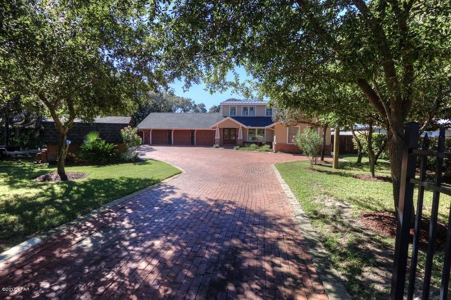 Absolutely over the top home located on North Lagoon on the WATER. Easy boat ride to the Gulf. Travel through the electronic gates to enjoy a huge brick driveway with 3 car garage and to view this recently and seamlessly remodeled home. Enjoy the covered boat slip with 10k lift which includes power, water, fish cleaning station and extra floating dock for swimming, paddleboards and kayaks. Fish off the dock, catch some crabs or just relax. There is a new enclosed salt water pool with solar heat, a fire pit and even a tree house with sand box! A newly added and large covered open porch is great for grilling or enjoying your morning coffee while watching the dolphins play. Ask your Realtor for the Video Link . Everything has been done for you. A new bedroom is off the foyer for company or aging parents with it's own HVAC, large closet and bathroom with handicap accessible shower. The kitchen is a cooks dream with kitchen island from HGTV's Magnolia, two multi-purpose living areas with tongue and groove cypress walls, and wooden beams surround a gas fireplace. For additional enjoyment, there is a glassed in sun room with incredible pool and water views. There's a total of 4 Bedrooms, 3 AND 1/2 baths with bonus private outdoor shower with hot and cold water. Private and perfect for use after swimming. You can choose to use the master bedroom upstairs with floor to ceiling Anderson windows or the newly remodeled master bedroom downstairs with jetted tub, double vanities and large closet with open views of the sunrise, lagoon and pool ! Upstairs has the optional master and another bedroom with customized shower and double vanities. New ceramic tile with wood floor look was added downstairs along with an on demand gas heating system, and additional storage. No detail was missed with this incredible remodel. MAKE SURE TO ASK YOUR REALTOR FOR THE VIDEO LINK