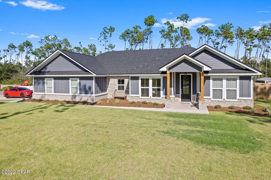 Do not miss this beautiful home in the breathtaking community of Cedar Creek. Nestled in a serene wooded paradise, this beautiful home is less than 1 year old! Located on a corner lot you have all the benefits of accessibility for your toys (RV, Camper, Boat, etc.) No expense was spared in upgrades ranging from: spray foam insulation, upgraded lighting package, interior brick accents, upgraded molding (shiplap, board and batten, window sashes, electric fireplace, mudroom built-in bench, custom soft close cabinetry, designer appliances, quartz counters, LVP, brick paver/tile flooring, and much more! Built by one of the top contractors in Bay County, Jeff Puckett, the quality is immediately recognized as soon as you walk in. The community amenities is one of a kind for Bay County. The amenities include but are not limited to the following: gated community, large community pool and covered area with bathrooms, picnic tables and outdoor fireplace. The clubhouse is the perfect place for birthday parties and get togethers. Behind the clubhouse is a wooded walkway that leads to a dock that sits on Deerpoint Lake, the perfect place to watch sunsets and fish and launch kayaks and paddleboards. The community was built with space and a natural setting in mind with this particular lot sitting on nearly 1 acre (more if you include the conservative easement that is accessible to this property). Pole barns are allowed!! Never worry about someone building behind you. Behind this home is a conservative easement and wetland area so it will always be protected.