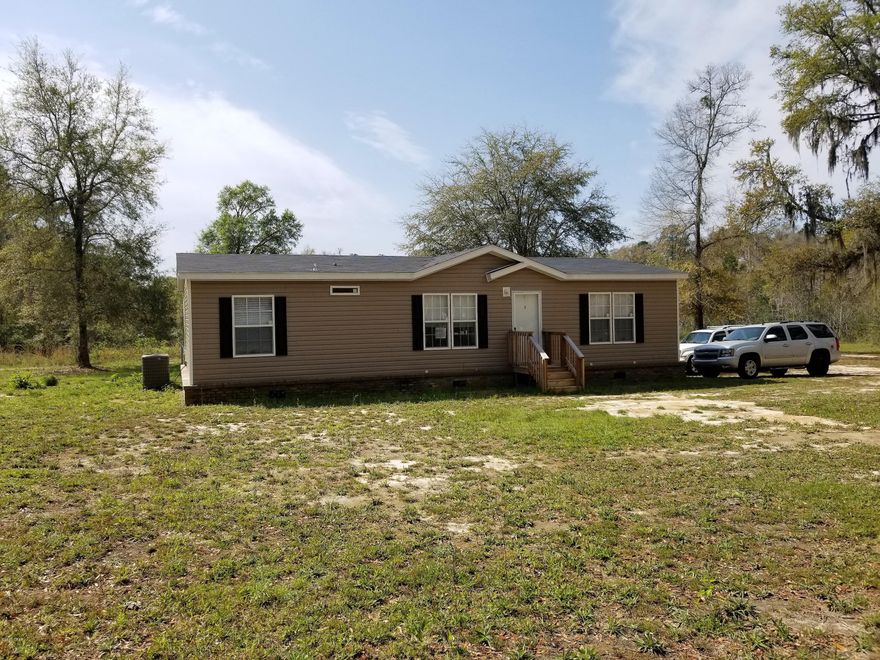 Absolutely beautiful 2017 Carriage Manor 2 mobile home with under ground power, city water and septic.  Located on a corner lot and has current survey.  Three bedrooms, two baths, master bath has a walk-in shower, garden tub and walk-in closet. Large open kitchen with center bar area, dining and living room.  Brick skirting, wood steps and hand-rails.  Chain link fenced in back yard.  Call for your appointment today.