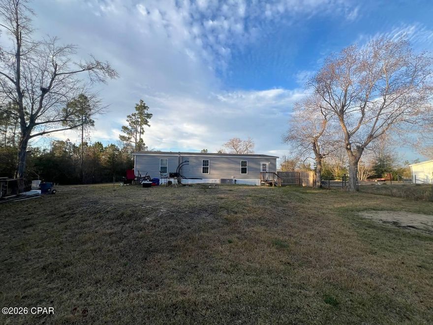 This is a relatively newer manufactured home (built around 2022) with 3 bedrooms and 2 bathrooms, offering roughly 1,458 square feet of living space on a modest lot in the Southport area of Panama City. It includes basic interior amenities like forced air heat