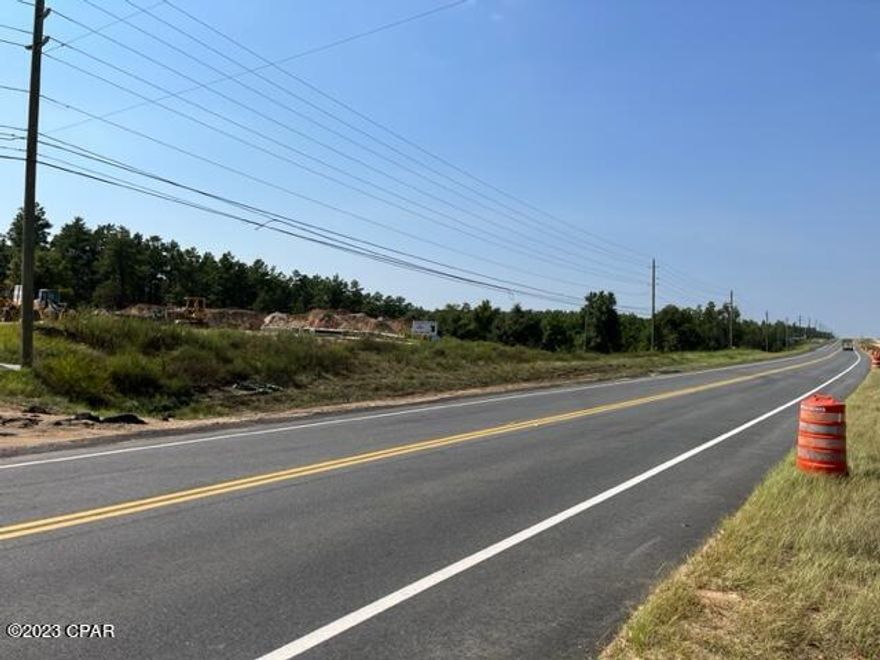 CURRENTLY UNDER CONTRACT, SELLER WILL CONSIDER BACKUP OFFERS  This 4 (+/-) acres on Highway 77 includes the commercial portion of 2 dual zoned acreage that has about 550 feet of highway frontage.  The front portion is already zoned commercial with the back portion of each of the 2 parcels is zoned residential. The Florida DOT is currently using one of the parcels for storage. The commercial portions are of parcels 00-3136-0308 and 00-3136-0309, In addition to highway frontage, the property also has a water view of the lake behind them. As the DOT is working on the highway expansion it will decrease the travel times going both directions. A recent survey is available.