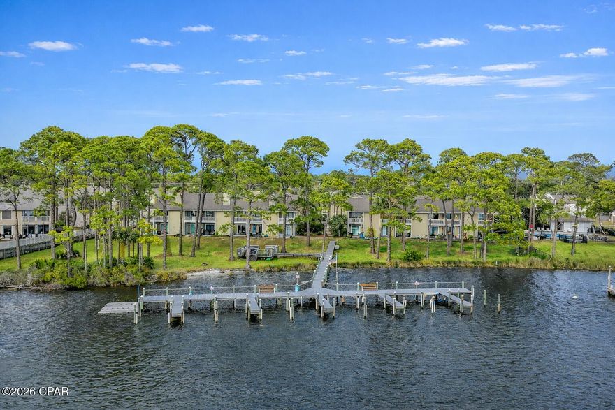 Rare lagoon-front opportunity in Panama City Beach! This 2-bedroom, 2-bath condo at Grand Lagoon Cove offers direct waterfront views, shared dock access, and a peaceful coastal setting along highly desirable North Lagoon Drive. Enjoy morning coffee from your covered balcony overlooking the water and green space. Inside, the unit features updated LVP flooring, stainless appliances, a water heater replaced in 2025, and HVAC updated in 2013. The open living area is comfortable and functional for full-time living, a second home, or long-term investment. Community amenities include a pool, tennis courts, BBQ area, and waterfront common areas. Short-term rentals are permitted per association guidelines (minimum rental period restrictions apply). Conveniently located near beaches, marinas, waterfront dining, shopping, and St. Andrews State Park. A rare chance to own waterfront property in Panama City Beach at an attractive price point.