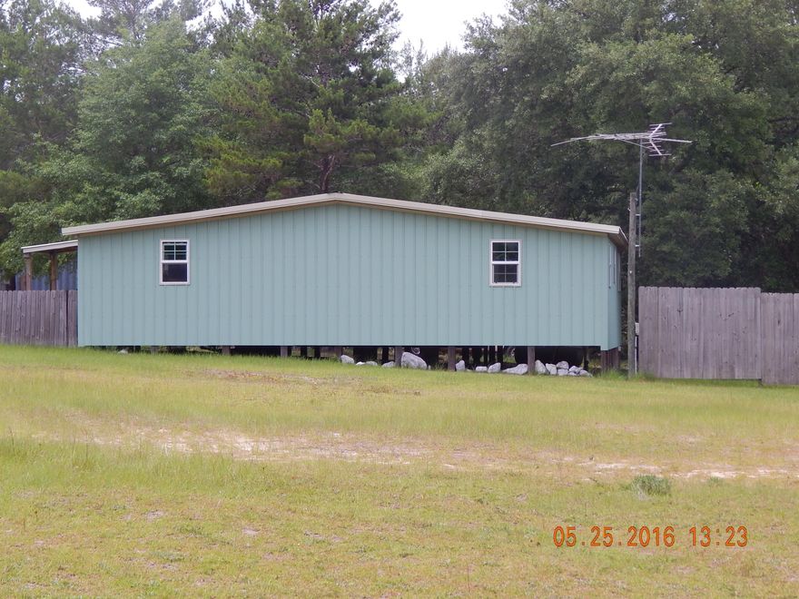 This is that ''One of a Kind'' property. Lots of possibilities. House has two bedrooms and two full baths. Large living and dining rooms and nice size kitchen. Along with that there are two container trailers two have electric and  one of those has plumbing and could easily be made into an additional living space. There is also an office trailer that has been gutted with new metal roof and windows,  so you have a clean pallet to create what ever you need it to be. Great for two families or an extra mother in law quarters. Storage containers are good for storage or secure workshop. Property is located within 30 min of The World's Most Beautiful Beaches, shopping, ect.....Private setting and mostly fenced. Surrounded by some of the best fishing in Northwest Florida.Come see it today