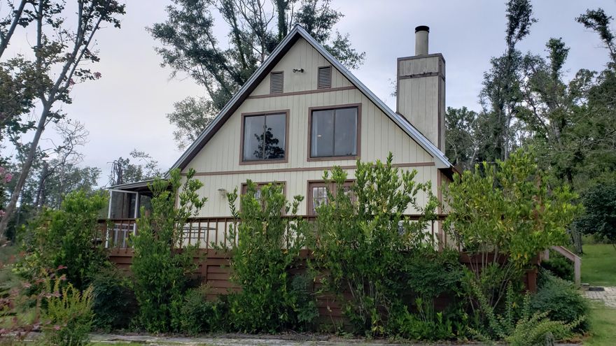 CURRENTLY UNDER CONTRACT, OWNER ACCEPTING BACK UP OFFERS. Sit back and relax in this 3/2 two story home in Compass Lake. Home sits back off of the road and has wooded lots surrounding it. The downstairs floor plan offers a open living room with a wood burning fireplace and dining area with 2 sets of french doors leading to the front porch and the screened in porch. Kitchen with lots of storage and breakfast bar, add a couple of stools for your quick meals. 2 bedrooms, full bath and laundry area. Upstairs you will find a sitting area that overlooks the downstairs and the view through to high situated windows. Master bedroom has french doors leading to a balcony to sit and listen to your secluded surroundings. Master bath with skylight for natural lighting. There is a large deck on the front and side of home great for entertaining. Newer metal roof and CH/A system. Most of the home furnishings will stay. Storage under the front deck. There is a voluntary $135 yearly fee paid to POA for access to the pool, lodge, boat ramp, and McCormick Lake. Not far from Compass Lake, a 581 acre spring fed lake is active for boating, canoeing, kayaking and skiing. McCormick Lake is 133 acres and only electric motors are allowed. There is also a restaurant on site. Not far from Hwy 231 for access to Panama City Beach to the south, Dothan, AL to the north and Interstate 10. Shown by appointment only as home is used as a Airbnb and has frequent visitors.