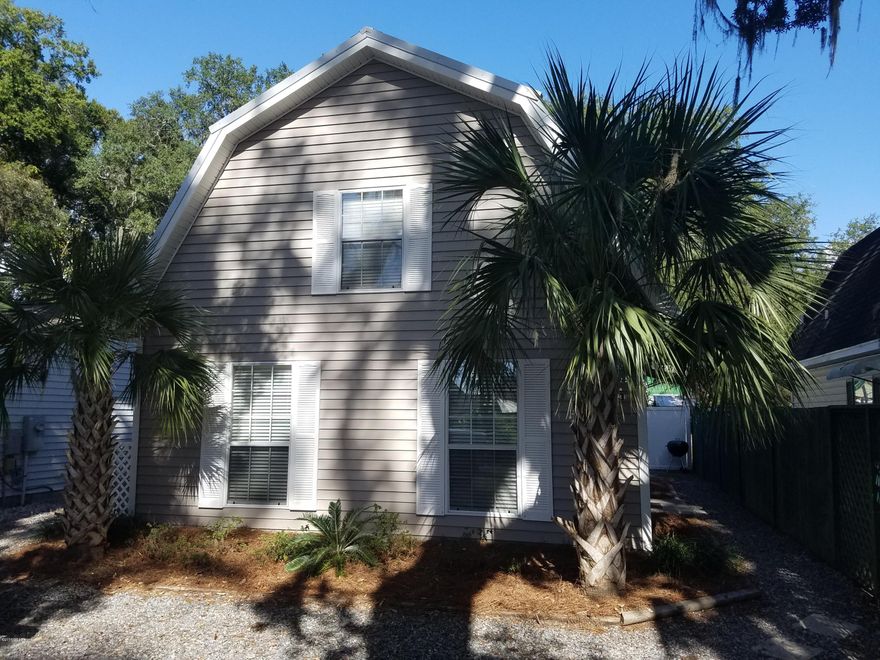 New on the Market! Just minutes from Tyndall! An amazing bayside cottage feel that is tastefully updated and ready to call home. Enjoy wonderful bay breezes in this neat and quiet neighborhood. The 2014 metal roof and vinyl siding is perfect for a low maintenance lifestyle. This two story home is bright and spacious with tons of natural light. Beautiful wood floors in the living space and kitchen. The kitchen offers updated cabinets and granite countertops. The bath space has been renovated and is very nice, it has granite countertops as well and two entrances for added convenience. Down stairs bedroom connects to bath and upstairs bedroom is loft style, both are nice size. There is a utility room in the back of home that offers plenty of storage and there is Still plenty of yard for cookouts with family and friends. You can see the bay from the yard and it is just steps across the street. A perfect place to watch the fireworks on the 4th. This home is like new and pride of ownership shows throughout. Schedule your visit today!