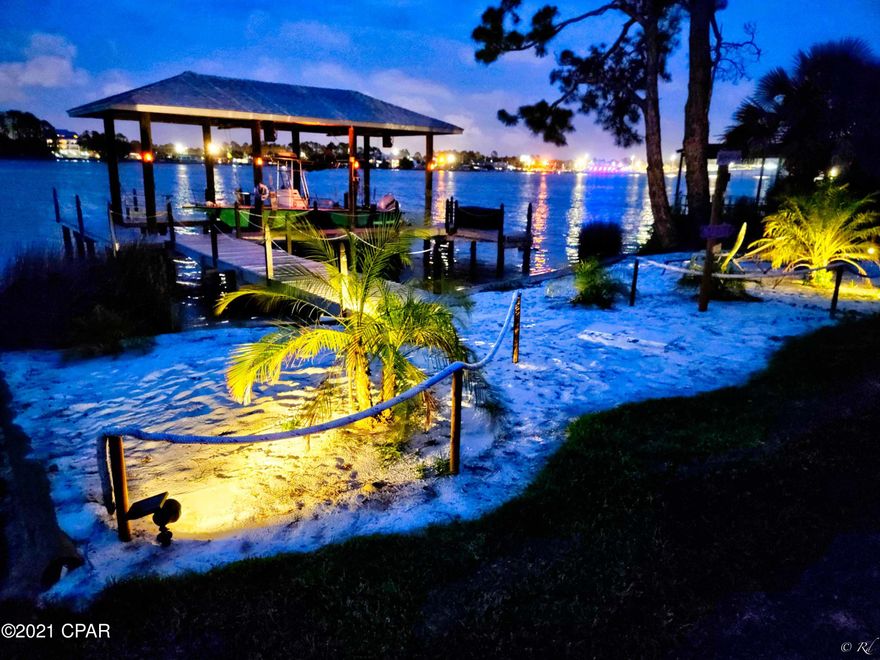 'CURRENTLY UNDER CONTRACT, SELLER ACCEPTING BACKUP OFFERS' Find your own Slice of Paradise in this beautiful waterfront home on Grand Lagoon. Beautiful open floor plan and a spacious eat in kitchen overlooking an entire WALL of windows providing an unrivaled view of the Lagoon.  The second floor boasts room for the entire family to hang out on the 33ft long deck with 4 spacious bedrooms and 4 full baths! Where else can you jump on a boat from your back yard to be at Shell Island within minutes, or...have your toes in the sand of our beautiful white beaches just a few short blocks away? This is a hard to find extra deep lot on South Lagoon. Contact your favorite realtor today for a showing! Call your favorite Realtor today and make an appointment to see this jewel quickly before it goes under contract! 

**ADDITIONAL KEY FEATURES**
-Deck includes gas fireplace
-Wind barrier BBQ area with pizza oven
-Vapor misters
-Maintenance free turf front yard
-Outdoor shower
-Security system
-Laundry room with sink
-Walk in Pantry
-Full bathroom on first floor