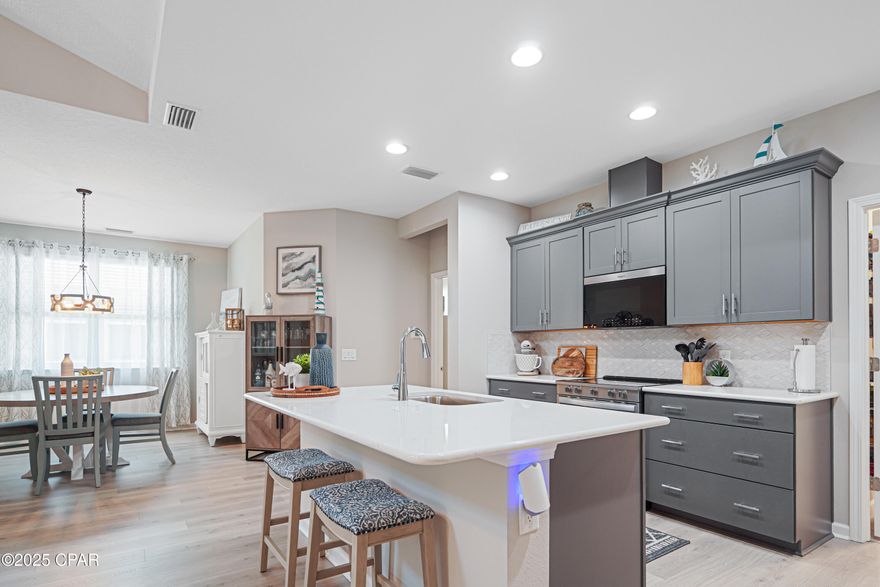 Carefree Coastal Living in Latitude Margaritaville Watersound! Welcome to the beautifully appointed Camellia Cottage, a perfect blend of comfort and style in one of the Gulf Coast's most sought-after 55+ communities. This charming home boasts a bright and airy great room with soaring cathedral ceilings and laminate flooring creating the perfect space to relax or entertain. The chef-inspired kitchen features elegant quartz countertops, a classic tile backsplash, upgraded electric range, microwave, and a large center island—ideal for casual dining or happy hour with friends. Just off the kitchen, a spacious dining area offers plenty of room for gatherings. Retreat to the spacious primary suite, complete with stylish tile flooring, a spa-like tile shower, dual quartz vanities, and a custom walk-in closet with built-ins for effortless organization. A comfortable guest bedroom and upgraded guest bath—with tile flooring, tile shower, and convenient grab bars—offer a welcoming space for visitors. Enjoy Florida's year-round sunshine from your private screened-in porch, the perfect spot for morning coffee or evening breezes.

Nestled within a vibrant golf-cart-friendly community with nearby trails and underpass access, this home offers the Margaritaville lifestyle at its finest—fun, freedom, and low maintenance. Your laid-back, luxury lifestyle awaits!

The amenities at Latitude Margaritaville Watersound offer a 2 story full service restaurant, resort style outdoor pool both overlooking the Intracoastal Waterway, A state of the art fitness center with an indoor lap pool and spa, fitness classes, water aerobics and more. Pickleball and tennis courts, a bandshell with a dance floor and music every Friday and Saturday night / activities year round. Kayak launch, game lawn with bocce ball, cornhole and ping pong. A theater, pet grooming, workshop and ceramics shop just opened. A future public marina and commercial area are planned with Publix grocery store, shopping and dining. 

This home has the builders Master Care warranty which in effect 2 years from original close date and a Builders 2/10 year structural warranty from the original build/close date. All lawn care is maintained by the HOA, exterior paint and roof replacement on a maintenance schedule are done by the HOA. Easy, carefree living! Must see this home and beautiful community! The lifestyle of this coastal Florida community awaits you!