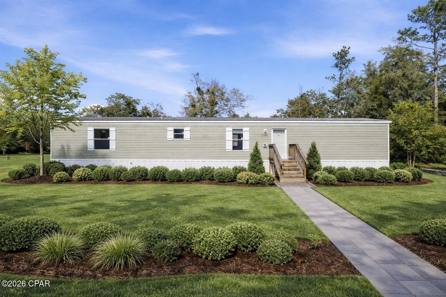 Welcome to your own peaceful retreat in Fountain! Built in 2022, this beautifully maintained manufactured home sits on an oversized property made up of two separate lots, offering extra space, privacy, and flexibility for future use. Inside, you'll love the bright open-concept design featuring durable wood-look flooring, recessed lighting, and a stunning beamed ceiling that adds warmth and character to the main living space. The kitchen is truly the heart of the home with crisp white cabinetry, stainless steel appliances, a large center island, and an inviting layout that flows effortlessly into the dining and living areas—perfect for entertaining or everyday living.

A standout feature is the charming coffee bar nook with custom shelving and a stylish accent wall, creating the perfect spot for morning routines or hosting guests. The primary suite provides a relaxing space to unwind with an en-suite bath featuring modern finishes and a spacious walk-in shower. Additional bedrooms offer flexibility for family, guests, or a home office. Thoughtful touches like the sliding barn door, ceiling fans, and abundant natural light complete the home's warm and welcoming feel.

Outside, enjoy wide open yard space with endless potential—room for toys, gardening, animals, or adding a workshop. Plus, the property includes two wells, providing added convenience and value. With newer construction, tasteful upgrades, and the benefit of two lots, this property is a fantastic opportunity to enjoy quiet country living while still being within reach of Panama City and surrounding areas.