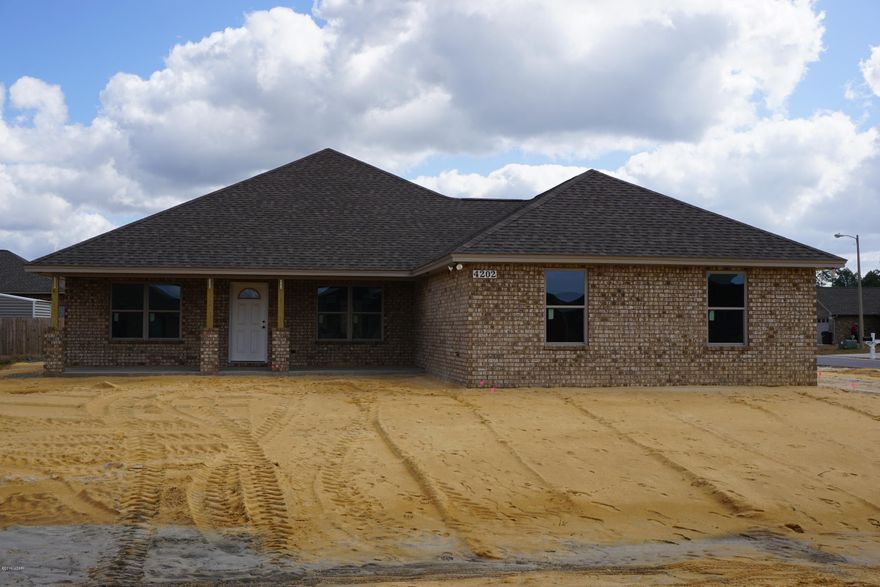 3 bedroom 2 bath all brick home with front porch and 3 car garage offers master bath with his & hers double shower with Rain maker (3 shower heads) and shower seats on both ends, and walk in closet. The kitchen is a dream with all real wood cabinets, solid surface countertops, and stainless steel appliances. There are cabinets in the laundry room. Living room with and electric fire place and crown molding. Home comes with a security system and generator ready electrical outlet with cord. Outdoors there is an enclosed screen patio, outside shower and sprinkler system. Home is built to 140 MPH wind code. At Bylsma Manor Estates with many homes already built and waiting for you to tour today