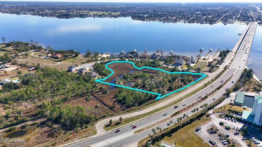 An exceptional opportunity to own a truly stunning property offering views of the bay, marsh, and bridge! Encompassing 4.58 acres on the northeast side of Bailey Bridge, this parcel is ideally suited for a private estate or a planned development. The land has been partially cleared and surveyed with the intent to divide it into two lots, allowing for the potential to build a duplex on each parcel, or pursue a larger residential or mixed-use project. Zoned for mixed use, the property allows for both residential and commercial development, with the possibility of constructing up to 11 townhomes. Water and sewer lines already run through the property, adding convenience and value for future development. Natural features include stunning wetlands and a pond, enhancing the beauty and privacy of the property. Located just a short distance from shopping, dining, and medical facilities in Lynn Haven and Panama City, and only minutes from the beach and Tyndall Air Force Base, this property offers a rare blend of natural beauty, flexibility, and prime location. This listing is for the purchase of the entire parcel—an outstanding investment with endless potential!