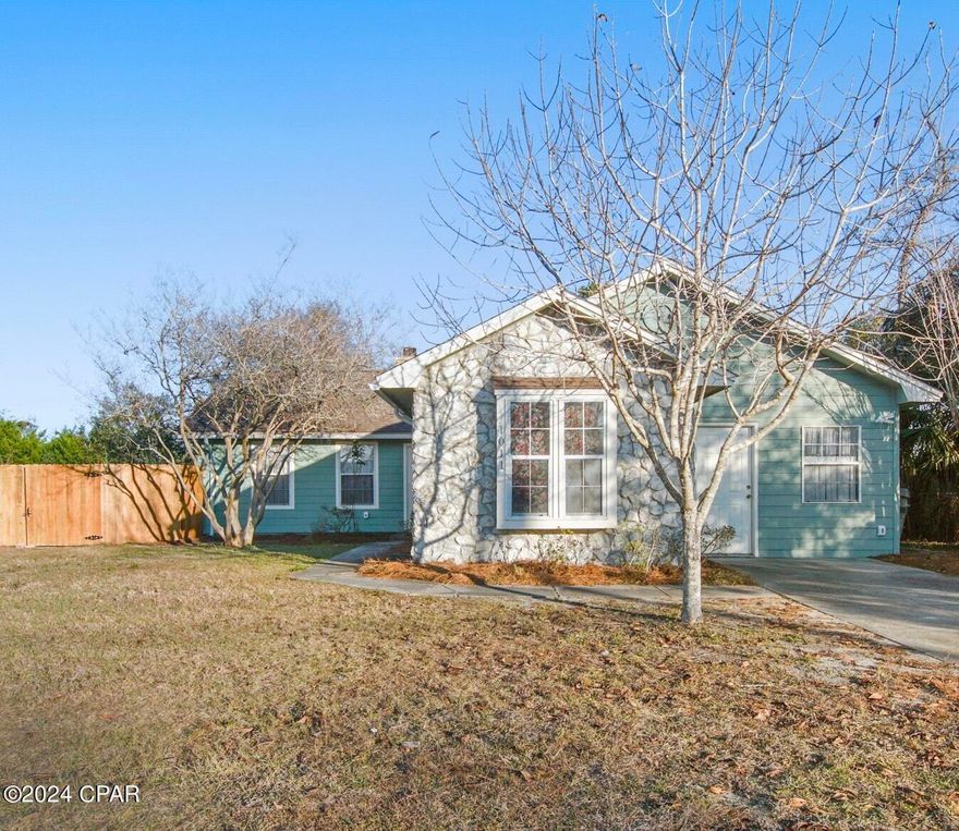 PRICE IMPROVEMENT!  This 3BR/2BA gem right in the heart of old Lynn Haven is now ready for you! You MUST see this home to appreciate it! This home is so special in that it can meet the common needs of multi generational living, extra revenue, or both!  In the front of the home, we have a kitchen/sitting area with a bedroom attached that would make an excellent apartment for an adult child, or a Mother in Law suite with its own entrance.  Off this area we have a bedroom and a shared bathroom, leading to a bright and sunny Florida Room that is large enough in size that it could be used as a family room/den, or recreational space if needed, also with its own entrance, and private deck! This room could also double as a 4th bedroom, as it does have its own closet.  We then move on to the galley kitchen with new stove, walk in pantry, and the main living space. This cozy living room comes with a stone fireplace for those chilly winter nights at home with the family, and overlooks the large, expansive backyard! The master suite is off the living room with its own sliding glass door leading to the back yard.  The only thing this home is missing is YOU! Grab your favorite Realtor and take a look today! **If measurements are important, buyer must measure and verify.**