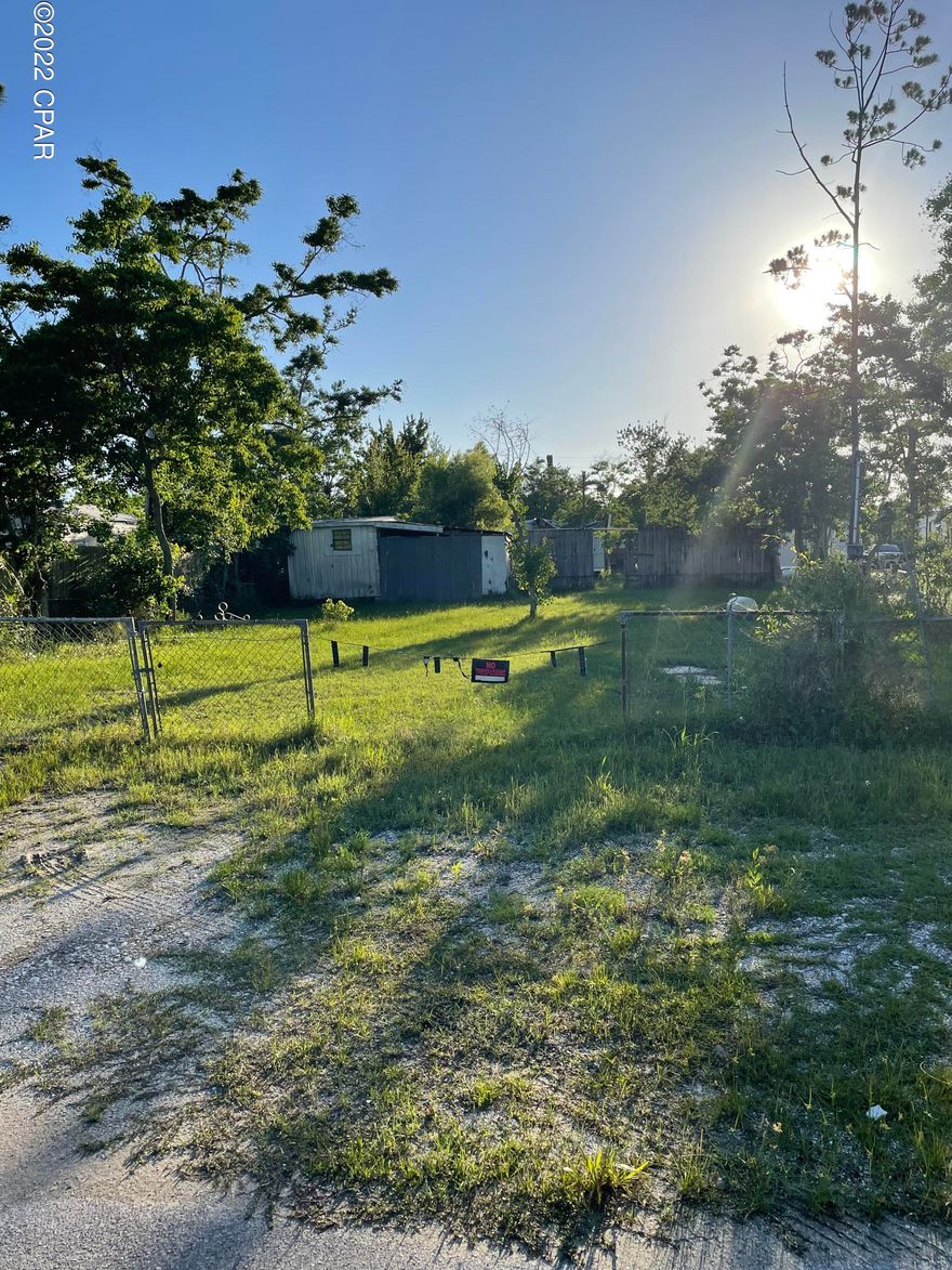 Back half of double lot, structures have no value, this is land only. Perfect place for your Manufactured Home!  Just a block from East Bay.
