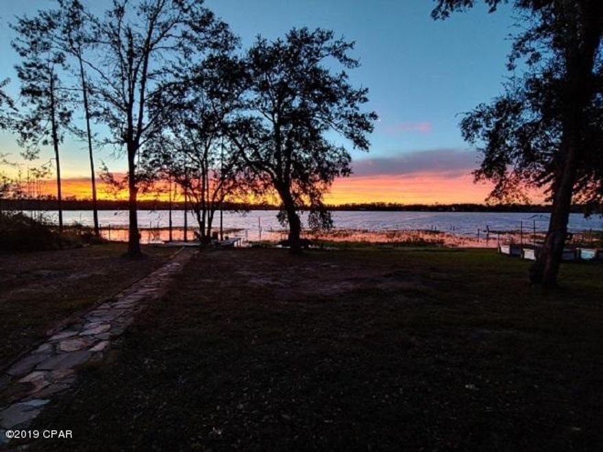 Waterfront home on the beautiful pristine  Silver Lake.  Easy level walk to the water and you are in.  2 lots totaling 1.2 ACRES. With over 124 ft of white sandy lake frontage.  Enjoy the many sunsets on the shoreline deck or your morning coffee to start the day.  Silver Lake is a no gas engine lake that is approx 265 acres and said to be 65 ft deep of crystal clear spring fed aqua blue water. Great recreational lake for fishing, kayaking, canoeing, paddle boating and scuba diving.  The rustic 2 story home with spectacular views of the lake from both the upstairs porch and downstairs open porch.  There's also eye catching views from the open living area inside the home.  Between the views and recent  upgrades in the home makes it hard to leave. See more... Upgrades include new bamboo flooring upstairs, new windows, vinyl padded waterproof planks downstairs, windows being newly installed, new roof & gutters, new stainless steel appliances, new light fixtures & outlets, new interior paint in 2018, new exterior stain 2019, new iron shield water system by EZ water, newly installed exterior stairs & screens to be installed in porch, new exterior ceiling fan and high energy efficient ceiling fans in the living area.  The custom built cypress kitchen cabinets features 14 inch deep top cabinets, full length deep drawers, under cabinet lights and outlets & under cabinet kick drawers. Tastefully chosen granite and a farmers sink tops off the overall look achieved by the owners hard work. Another one of the owners talents went into the interior stairs by replacing the steps with reclaimed poplar wood and the downstairs bathroom cabinets made from reclaimed cypress. The local cypress tongue & grove wood used for the kitchen ceiling was chosen to closely match the kitchen cabinets.  The heat pump was replaced to a Trane Geo Thermal unit. For your guests there is a detached bedroom with half bath which has an on demand water heater, mini split AC unit, new vinyl waterproof plank flooring, new roof and windows and a private screen porch with a view of the lake.  This detached living space can be used as an art studio, private office or a game room.  Attached to this building is the lawn equipment storage building. This home does have a wood burning buck stove in the 
main living area, outside security lights, auto garage opener, raised garden beds, large walk in closet in master bedroom, a fire wood box, a nice patio with brick BBQ & two swings.