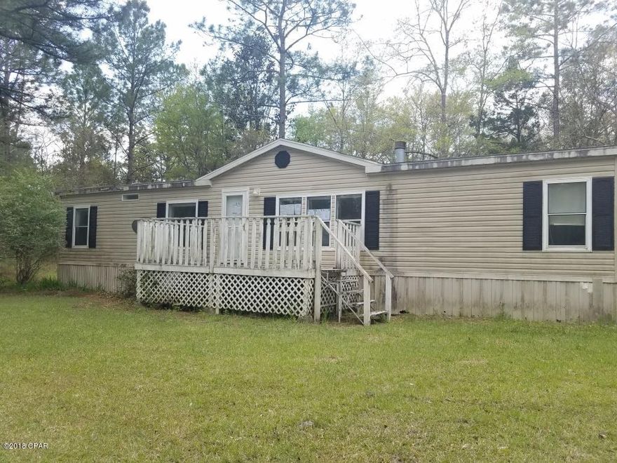 WOW Looking for the Country Living Close to town well Look no further!! This 3 Bedroom 2 Bath DWMH has 1568 sq. ft. Open Living room with fireplace, Pass thru kitchen window. The kitchen has all appliances! Split Bedroom Plan. Master Bath has garden tub, separate shower and double sinks! The property is 15.98 acres with 3.67 in flood zone X. 12.31 Acres in Flood Zone A.  Great for hunting on your own property!! Owner Occupants only at this time. Call for more information. Sold AS-IS.