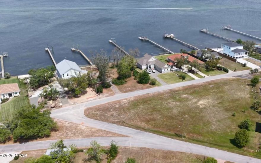 Prime development opportunity in one of Panama City's most desirable coastal corridors. Conveniently located just minutes from Gulf Coast State College and Florida State University Panama City campus. This ±0.80-acre parcel offers exceptional potential for builders, developers, and investors looking to maximize returns in a high demand area. Positioned just across from the bay and surrounded by established homes, this property is ideally suited for subdivision into 4/5 residential lots  or a custom smaller scale development. With its proximity to the bay, a multi story build may offer the opportunity for water views, adding long term value and appeal. With three sides of road frontage, access and layout flexibility make this site especially attractive for multiple build scenarios.  Opportunities like this are hard to find.  Motivated to sell! This location adds even more value, minutes from waterfront access, dining, shopping, and the continued growth of the Panama City market. Demand for new construction and short term rental opportunities in this area remains strong, making this a compelling play for both builders and long term investors.